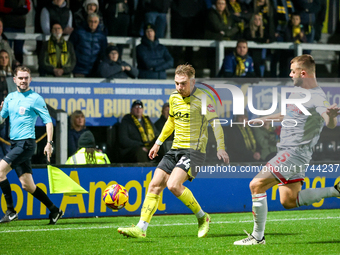 Charlie Barker of Crawley Town races to intercept Ben Whitfield of Burton Albion during the Sky Bet League 1 match between Burton Albion and...