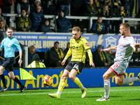 Charlie Barker of Crawley Town races to intercept Ben Whitfield of Burton Albion during the Sky Bet League 1 match between Burton Albion and...