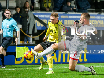 Number 34, Ben Whitfield of Burton Albion, is intercepted by number 5, Charlie Barker of Crawley Town during the Sky Bet League 1 match betw...