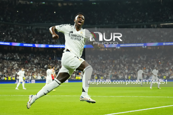 Vinicius Junior left winger of Real Madrid and Brazil celebrates after scoring his sides first goal during the UEFA Champions League 2024/25...