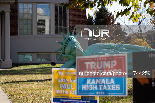 Zaq Landsberg's ''Reclining Liberty'' statue lies on the lawn behind campgain signs at the Museum of Contemporary Art, a polling place in Ar...