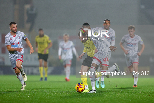 Number 34, Ben Whitfield of Burton Albion, and number 20, Joy Mukena of Crawley Town, battle for possession during the Sky Bet League 1 matc...