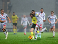 Number 34, Ben Whitfield of Burton Albion, and number 20, Joy Mukena of Crawley Town, battle for possession during the Sky Bet League 1 matc...