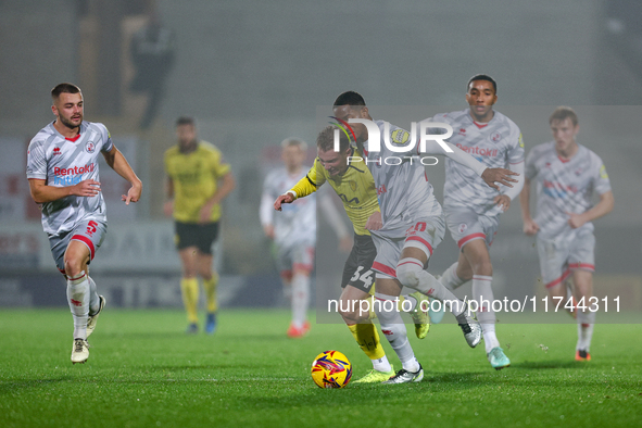 Number 34, Ben Whitfield of Burton Albion, and number 20, Joy Mukena of Crawley Town, battle for possession during the Sky Bet League 1 matc...