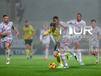 Number 34, Ben Whitfield of Burton Albion, and number 20, Joy Mukena of Crawley Town, battle for possession during the Sky Bet League 1 matc...