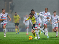 Number 34, Ben Whitfield of Burton Albion, and number 20, Joy Mukena of Crawley Town, battle for possession during the Sky Bet League 1 matc...