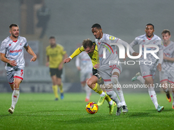 Number 34, Ben Whitfield of Burton Albion, and number 20, Joy Mukena of Crawley Town, battle for possession during the Sky Bet League 1 matc...