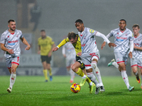 Number 34, Ben Whitfield of Burton Albion, and number 20, Joy Mukena of Crawley Town, battle for possession during the Sky Bet League 1 matc...