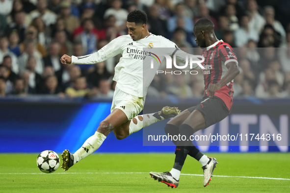 Jude Bellingham central midfield of Real Madrid and England  shooting to goal front Fikayo Tomori centre-back of AC Milan and England during...