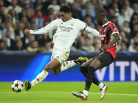 Jude Bellingham central midfield of Real Madrid and England  shooting to goal front Fikayo Tomori centre-back of AC Milan and England during...