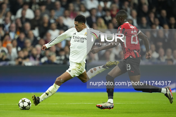 Jude Bellingham central midfield of Real Madrid and England  shooting to goal front Fikayo Tomori centre-back of AC Milan and England during...