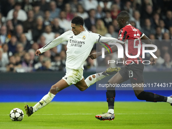 Jude Bellingham central midfield of Real Madrid and England  shooting to goal front Fikayo Tomori centre-back of AC Milan and England during...