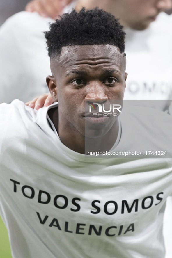 Vinicius Jr of Real Madrid shows a t-shirt supporting Valencia during the UEFA Champions League 2024/25 match between Real Madrid and AC Mil...