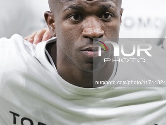 Vinicius Jr of Real Madrid shows a t-shirt supporting Valencia during the UEFA Champions League 2024/25 match between Real Madrid and AC Mil...