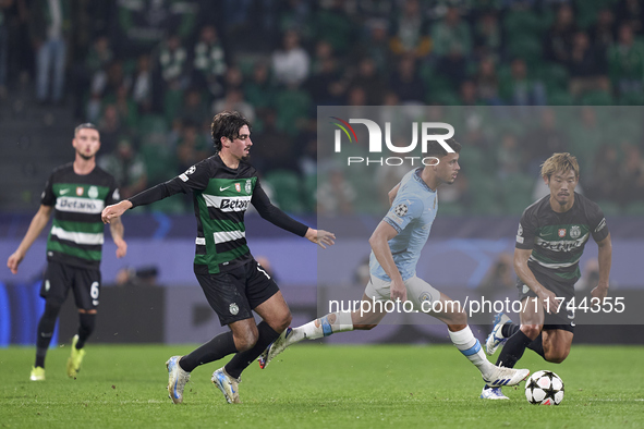 Matheus Nunes of Manchester City is challenged by Francisco Trincao (left) and Hidemasa Morita (right) of Sporting CP during the UEFA Champi...