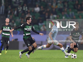 Matheus Nunes of Manchester City is challenged by Francisco Trincao (left) and Hidemasa Morita (right) of Sporting CP during the UEFA Champi...