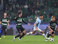 Matheus Nunes of Manchester City is challenged by Francisco Trincao (left) and Hidemasa Morita (right) of Sporting CP during the UEFA Champi...