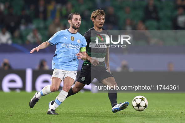 Bernardo Silva of Manchester City is challenged by Hidemasa Morita of Sporting CP during the UEFA Champions League match between Sporting CP...