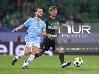 Bernardo Silva of Manchester City is challenged by Hidemasa Morita of Sporting CP during the UEFA Champions League match between Sporting CP...