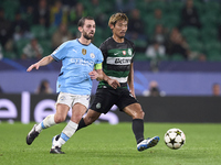 Bernardo Silva of Manchester City is challenged by Hidemasa Morita of Sporting CP during the UEFA Champions League match between Sporting CP...