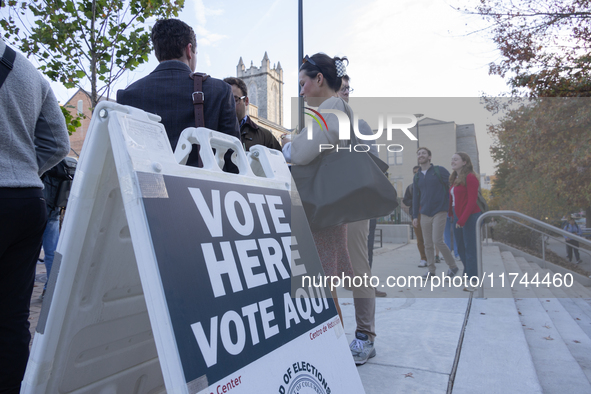 Voters stand in line at a local polling station in Washington, DC, on November 5, 2024. Americans cast their ballots in the presidential rac...