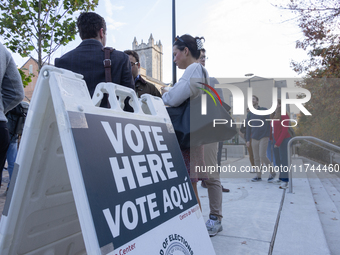 Voters stand in line at a local polling station in Washington, DC, on November 5, 2024. Americans cast their ballots in the presidential rac...