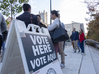 Voters stand in line at a local polling station in Washington, DC, on November 5, 2024. Americans cast their ballots in the presidential rac...