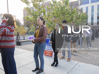 Voters stand in line at a local polling station in Washington, DC, on November 5, 2024. Americans cast their ballots in the presidential rac...