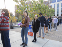 Voters stand in line at a local polling station in Washington, DC, on November 5, 2024. Americans cast their ballots in the presidential rac...