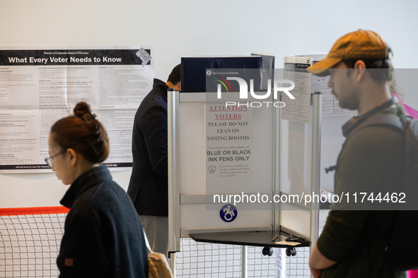 Voters stand in line at a local polling station in Washington, DC, on November 5, 2024. Americans cast their ballots in the presidential rac...