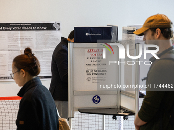 Voters stand in line at a local polling station in Washington, DC, on November 5, 2024. Americans cast their ballots in the presidential rac...