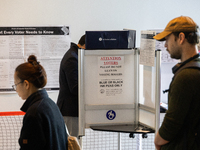 Voters stand in line at a local polling station in Washington, DC, on November 5, 2024. Americans cast their ballots in the presidential rac...