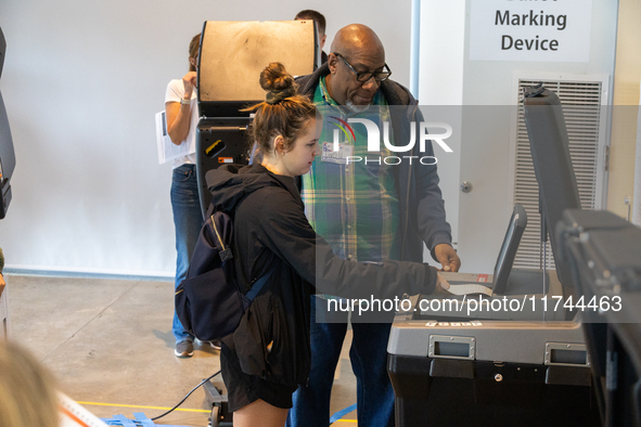 Voters stand in line at a local polling station in Washington, DC, on November 5, 2024. Americans cast their ballots in the presidential rac...