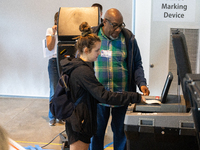 Voters stand in line at a local polling station in Washington, DC, on November 5, 2024. Americans cast their ballots in the presidential rac...