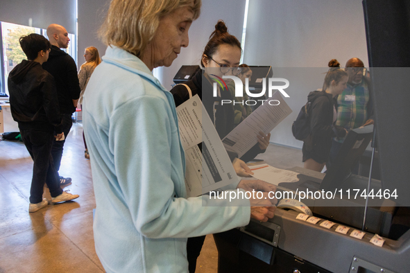 Voters stand in line at a local polling station in Washington, DC, on November 5, 2024. Americans cast their ballots in the presidential rac...