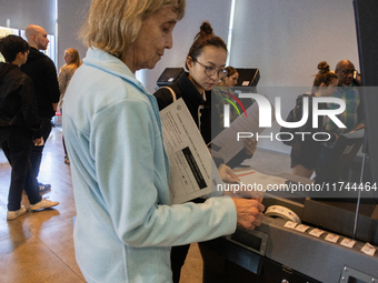 Voters stand in line at a local polling station in Washington, DC, on November 5, 2024. Americans cast their ballots in the presidential rac...