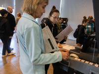 Voters stand in line at a local polling station in Washington, DC, on November 5, 2024. Americans cast their ballots in the presidential rac...