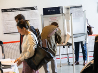 Voters stand in line at a local polling station in Washington, DC, on November 5, 2024. Americans cast their ballots in the presidential rac...