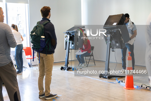 Voters stand in line at a local polling station in Washington, DC, on November 5, 2024. Americans cast their ballots in the presidential rac...