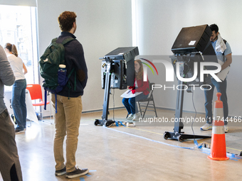 Voters stand in line at a local polling station in Washington, DC, on November 5, 2024. Americans cast their ballots in the presidential rac...