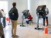 Voters stand in line at a local polling station in Washington, DC, on November 5, 2024. Americans cast their ballots in the presidential rac...