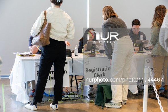 Voters stand in line at a local polling station in Washington, DC, on November 5, 2024. Americans cast their ballots in the presidential rac...