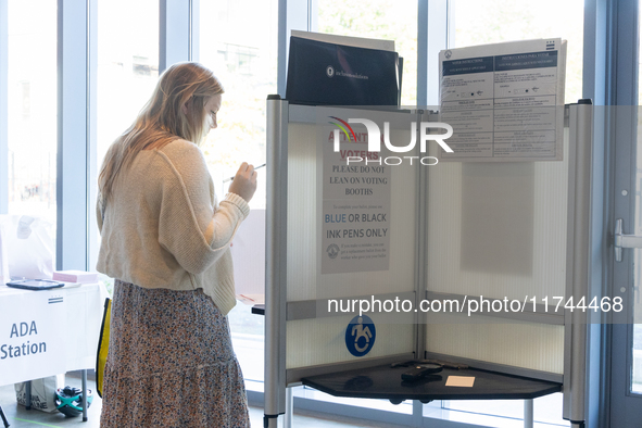 Voters stand in line at a local polling station in Washington, DC, on November 5, 2024. Americans cast their ballots in the presidential rac...