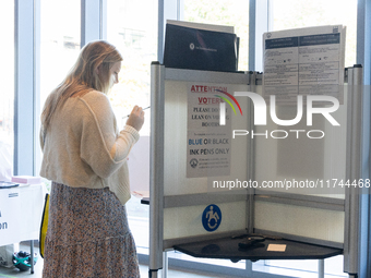 Voters stand in line at a local polling station in Washington, DC, on November 5, 2024. Americans cast their ballots in the presidential rac...