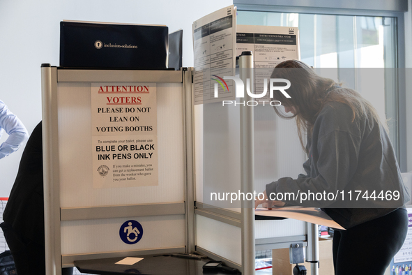 Voters stand in line at a local polling station in Washington, DC, on November 5, 2024. Americans cast their ballots in the presidential rac...