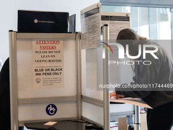 Voters stand in line at a local polling station in Washington, DC, on November 5, 2024. Americans cast their ballots in the presidential rac...