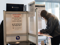 Voters stand in line at a local polling station in Washington, DC, on November 5, 2024. Americans cast their ballots in the presidential rac...