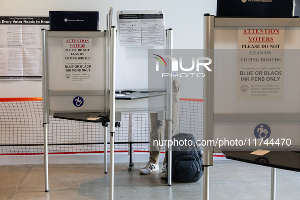 Voters stand in line at a local polling station in Washington, DC, on November 5, 2024. Americans cast their ballots in the presidential rac...