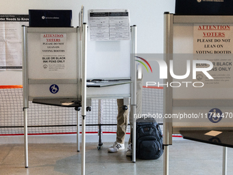 Voters stand in line at a local polling station in Washington, DC, on November 5, 2024. Americans cast their ballots in the presidential rac...