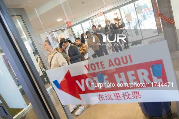 Voters stand in line at a local polling station in Washington, DC, on November 5, 2024. Americans cast their ballots in the presidential rac...